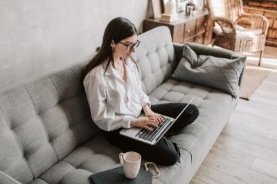 The Benefits of Remote Work image of woman working on her couch
